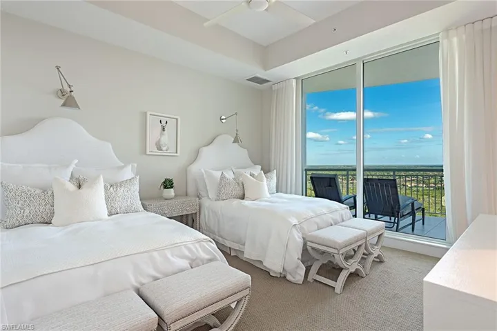 Carpeted bedroom with access to outside and ceiling fan