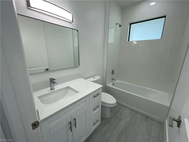 Full bathroom featuring bathing tub / shower combination, vanity, and toilet