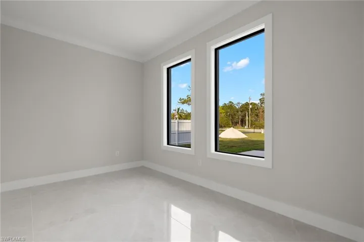 Tiled spare room with ornamental molding