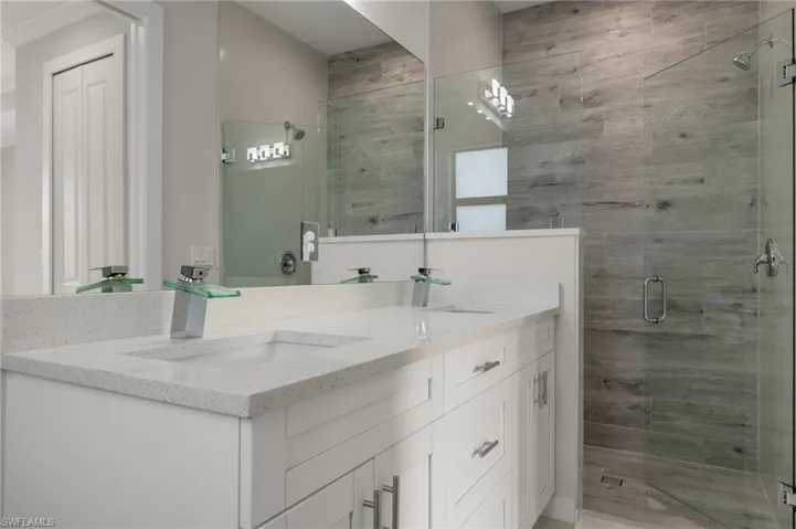 Bathroom featuring vanity and an enclosed shower