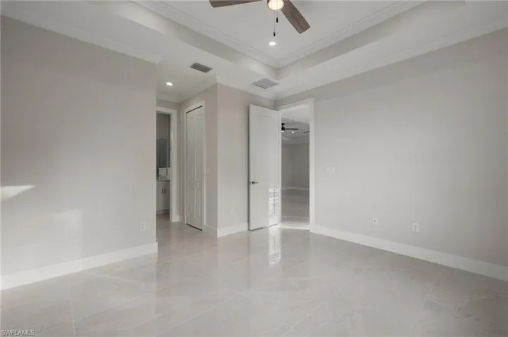 Unfurnished bedroom featuring crown molding and ceiling fan
