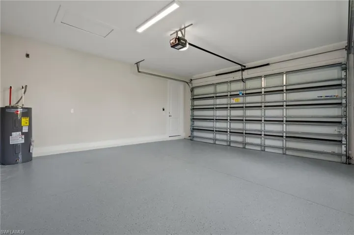 Garage with electric water heater and a garage door opener