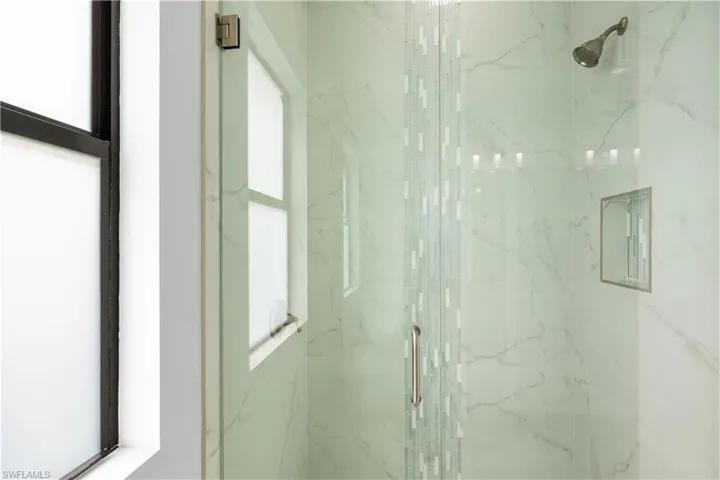 Bathroom with a marble finish shower