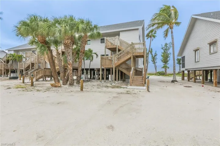 Back of house featuring stairs and a deck
