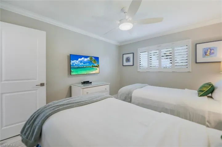 Bedroom featuring crown molding and ceiling fan