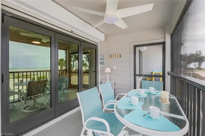 Sunroom / solarium with a ceiling fan, outdoor dining area, and french doors