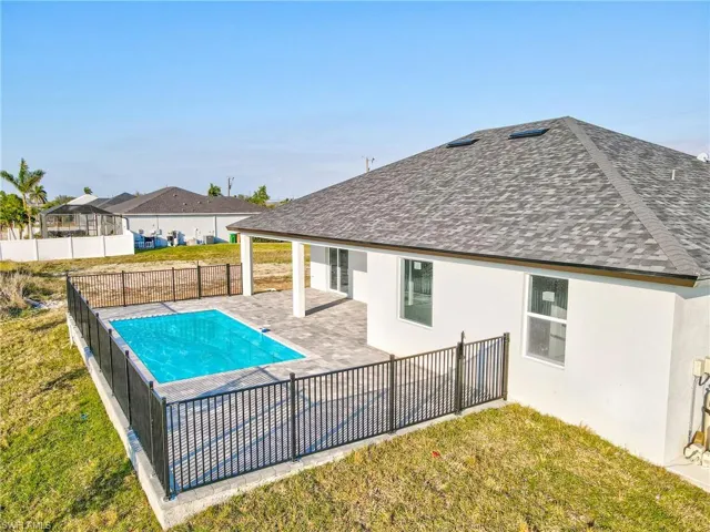 View of swimming pool with a patio, a fenced backyard, a fenced in pool, and a lawn
