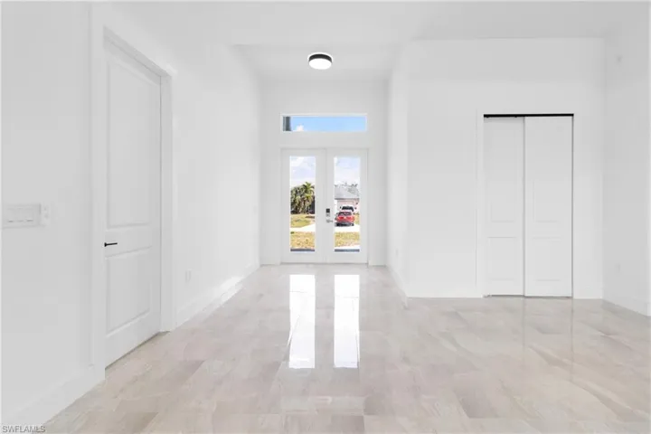 Corridor with french doors and baseboards