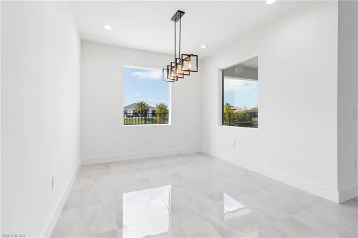Empty room with baseboards and recessed lighting