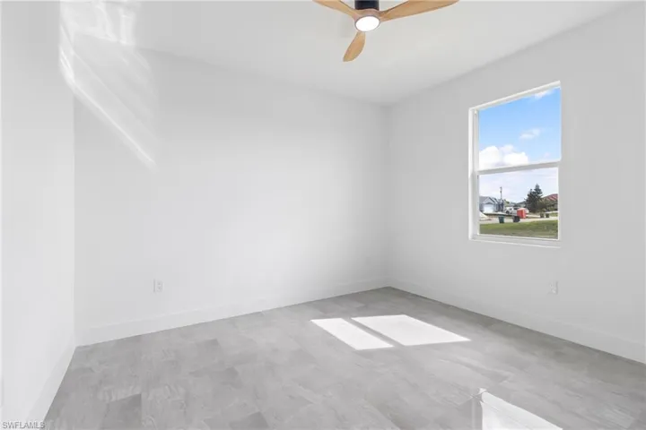 Spare room with baseboards and a ceiling fan