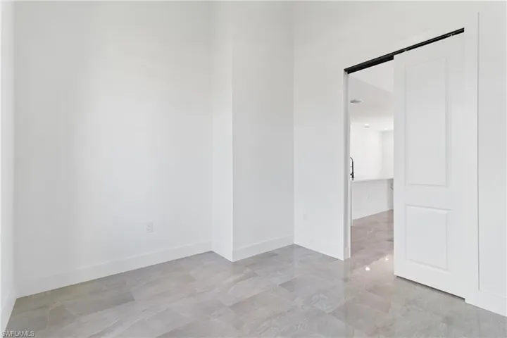 Empty room featuring baseboards
