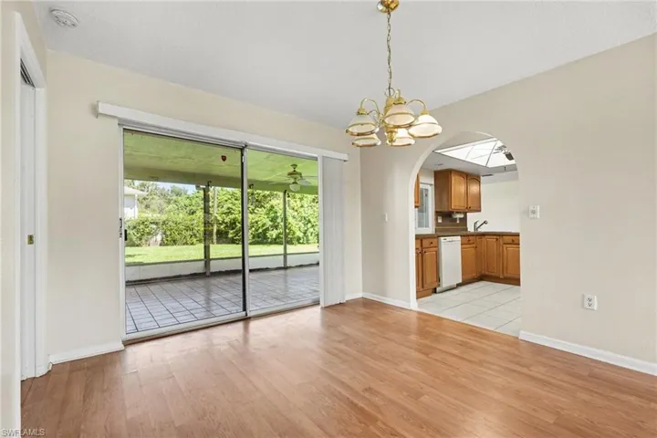 Dining room looking out to lanai and into kitchen