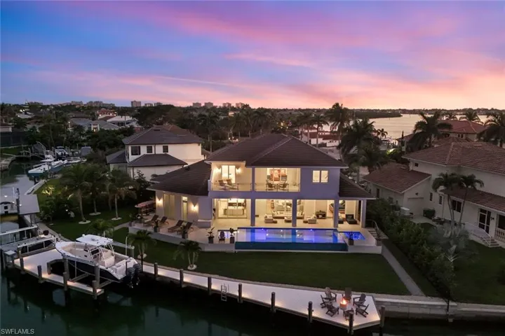 124 ft dock with fire pit, boat lift, & jet ski lift.  Covered and open lanais.