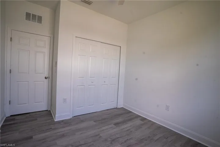 Bright interior space featuring wood-finish flooring and white baseboards