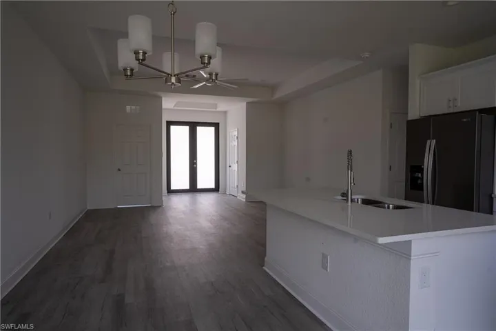 Kitchen island with a white countertop and integrated double-basin stainless steel sink