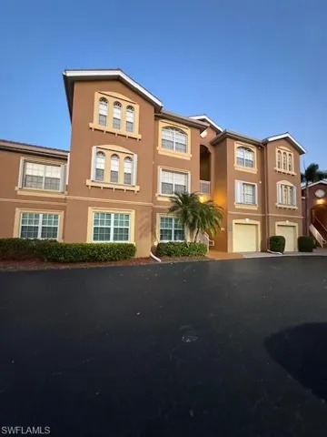 View of front of house featuring an attached garage and stucco siding