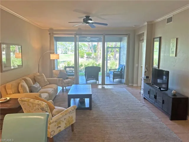 Living room featuring ornamental molding, plenty of natural light, and ceiling fan