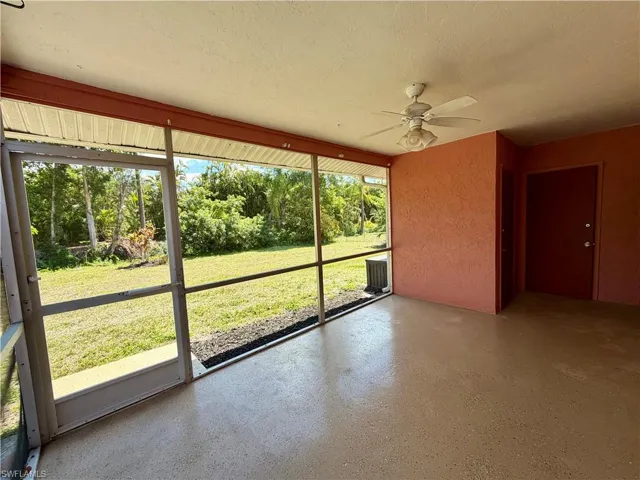 Unfurnished sunroom with a ceiling fan