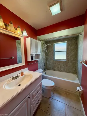 Bathroom with vanity,  shower combination, and light tile patterned flooring