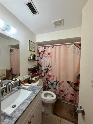 19209 - Full bath featuring vanity and light tile patterned floors