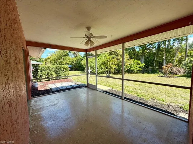 Unfurnished sunroom featuring ceiling fan