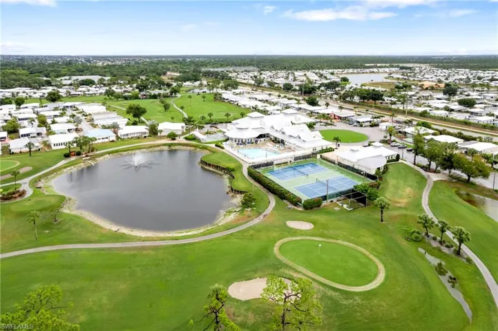 Aerial overview of property's location with a nearby body of water, nearby suburban area, and a golf club