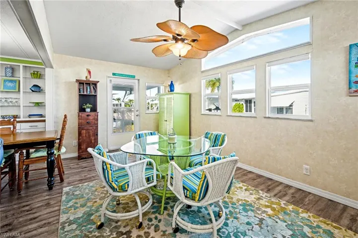 Dining room featuring a ceiling fan, wood finished floors, and built in features