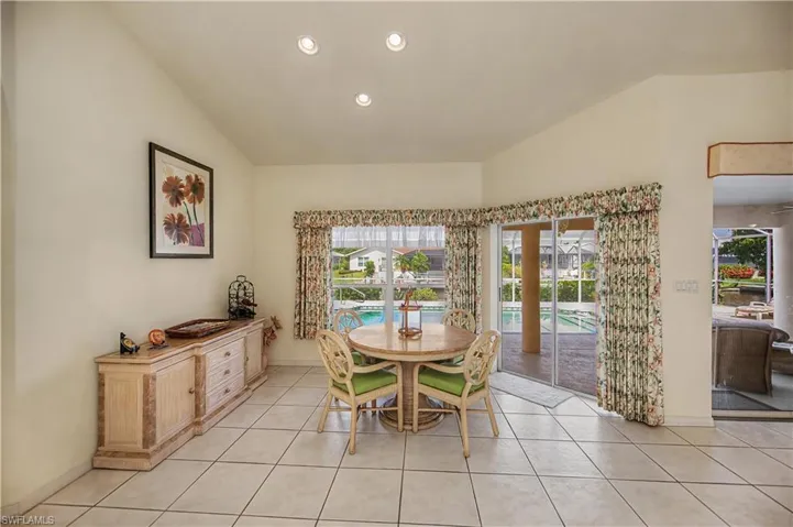 Vaulted ceilings and recessed lighting illuminate this dining area