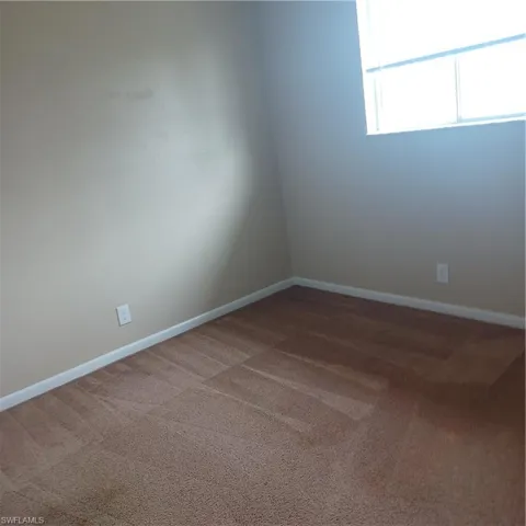 Spare room featuring carpet flooring
