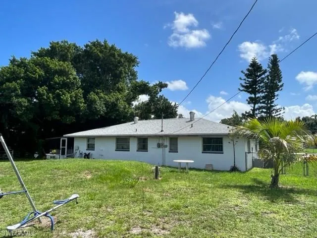 Rear view of house with a lawn