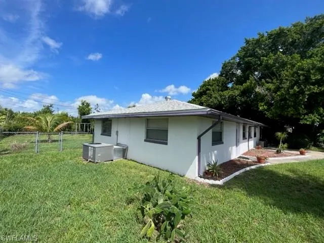 View of property exterior featuring a yard