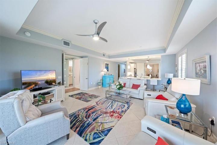 Great Room With High Tray Ceiling & Crown Molding Throughout