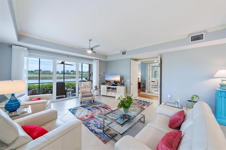 Great Room With High Tray Ceiling & Crown Molding Throughout