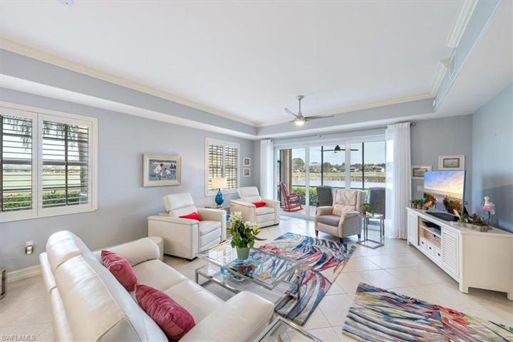 Great Room With High Tray Ceiling & Crown Molding Throughout