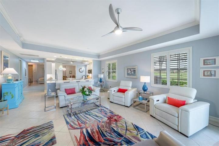Great Room With High Tray Ceiling & Crown Molding Throughout