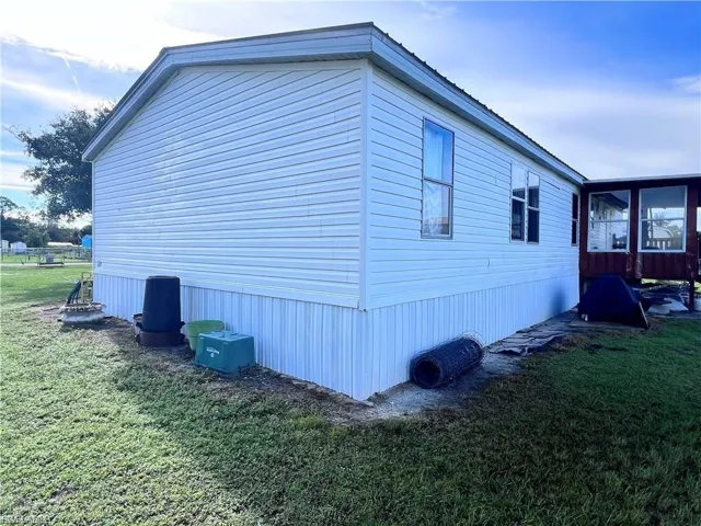 View of home's exterior with a yard
