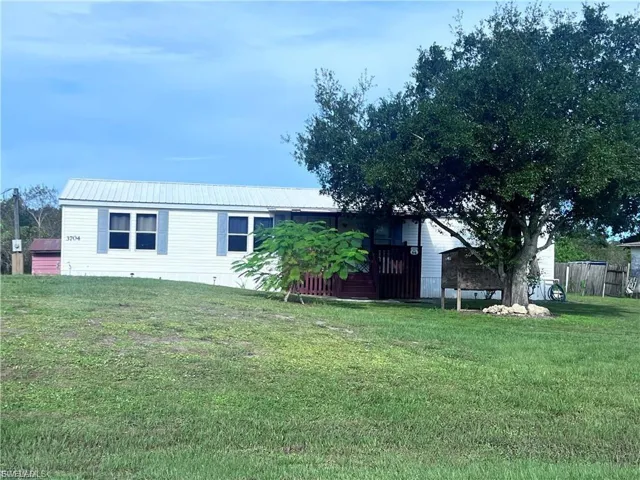 View of front of home with a front lawn and a metal roof