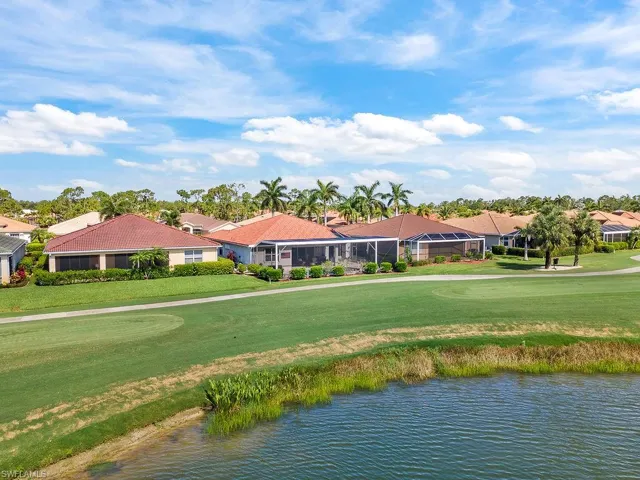 Water view with a golf club and nearby suburban area