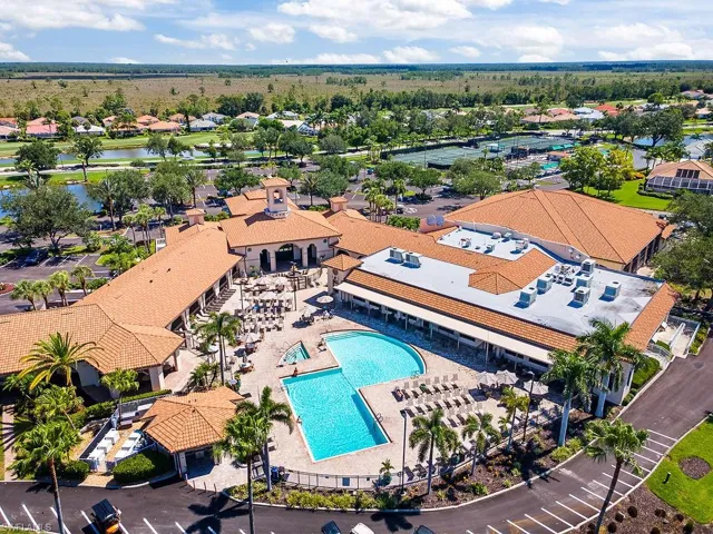 Drone / aerial view of a pool and a nearby body of water