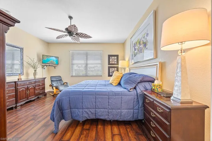 Bedroom featuring dark wood-type flooring and ceiling fan
