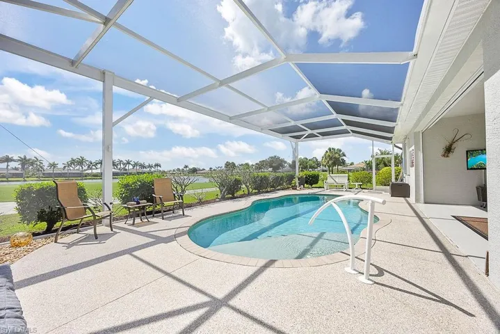 Outdoor pool with a patio area and a lanai