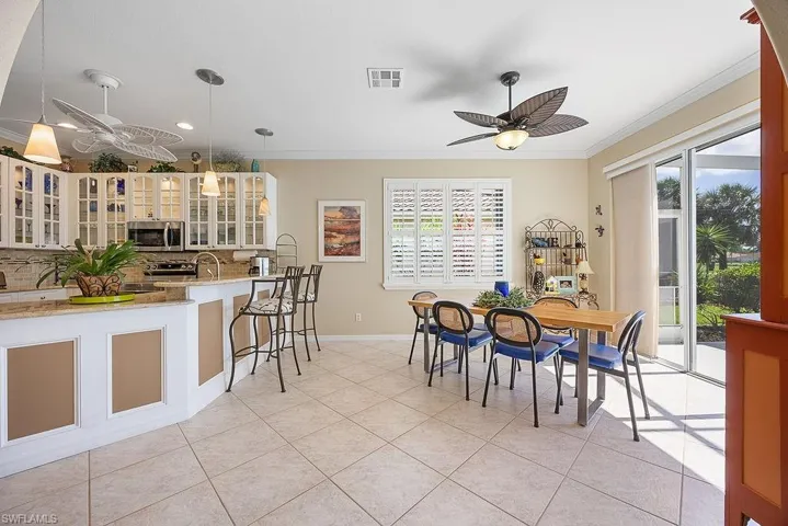 Dining room with ceiling fan, crown molding, healthy amount of natural light, recessed lighting, and light tile patterned flooring