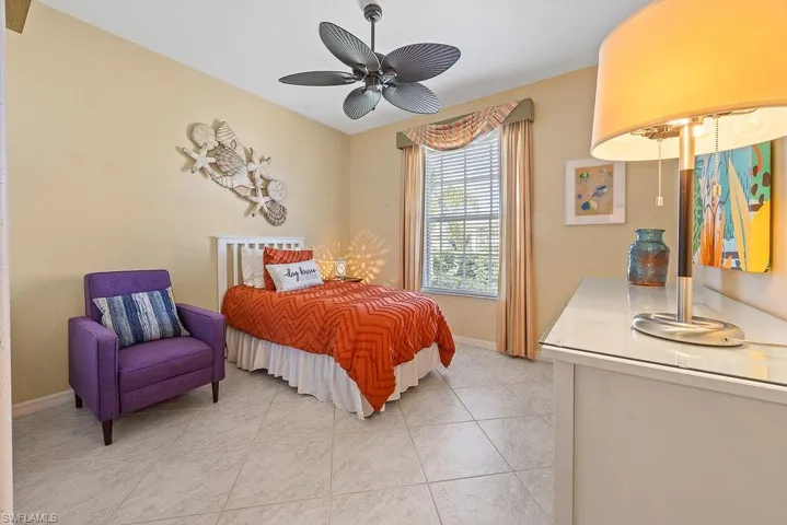 Bedroom featuring light tile patterned floors and a ceiling fan