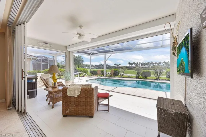 Outdoor pool featuring a ceiling fan, a patio, and a lanai