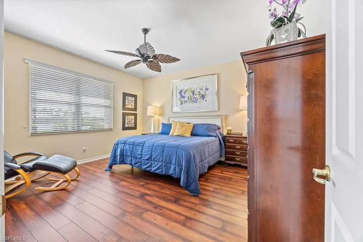 Bedroom featuring wood-type flooring and a ceiling fan