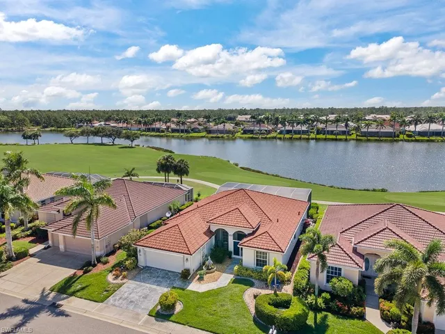 Aerial perspective of suburban area featuring a large body of water