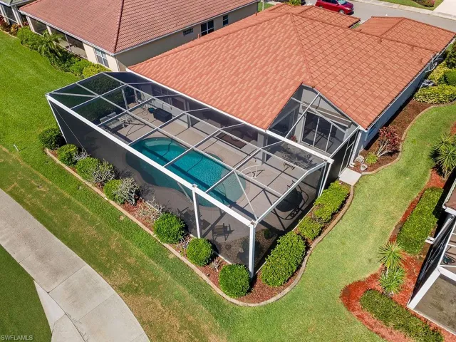 Aerial view of property and surrounding area featuring a pool
