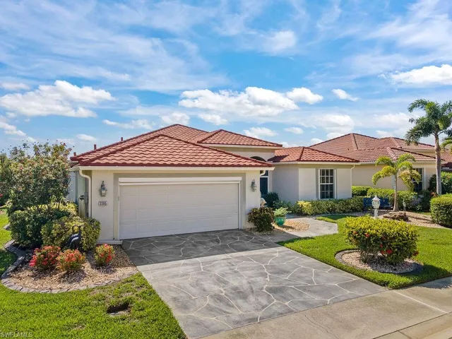 Mediterranean / spanish-style house with an attached garage, stucco siding, a tile roof, and concrete driveway