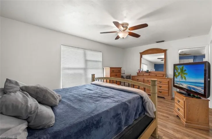 Bedroom with light hardwood / wood-style flooring and ceiling fan