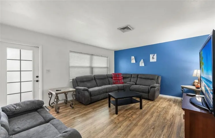 Living room featuring dark hardwood / wood-style flooring